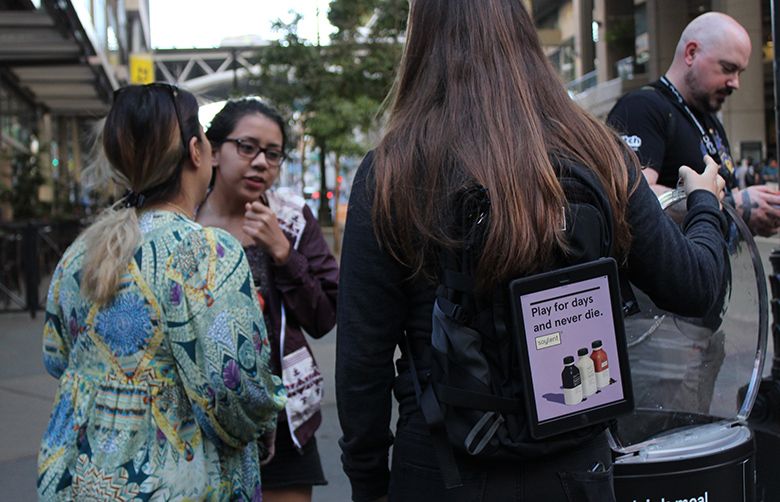 “Nomad” Elena Larsen displays a Soylent ad on her backpack in Seattle in September, 2017. (Credit: Nomad Technologies)