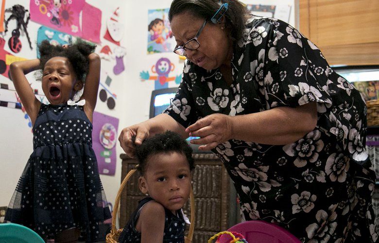 Cheryl Givens-Perkins brushes her granddaughters’ hair for church. Givens-Perkins cares for her three grandchildren after her daughter Cassaundra Lynn Perkins died of an infection just over a week after giving birth to her twins. She was 21. (Ilana Panich-Linsman/Los Angeles Times/TNS) 1214680 1214680