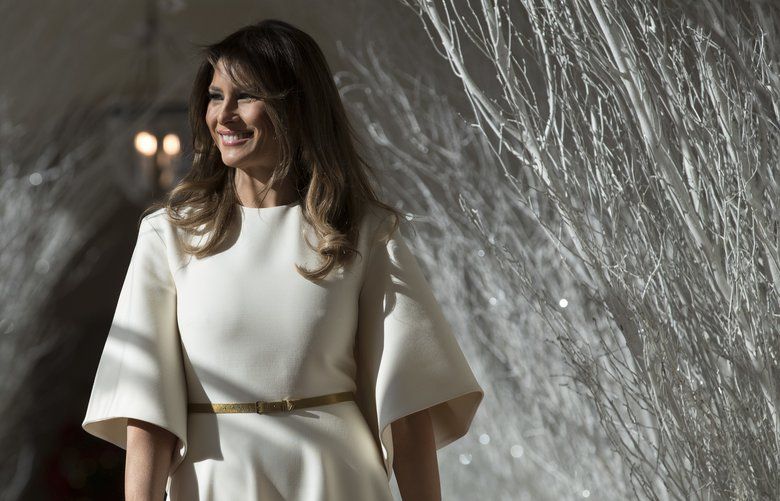 First lady Melania Trump walks along the East Colonnade decorated in white branches that are part of 2017 holiday decorations with the theme “Time-Honored Traditions” at the White House in Washington, Monday, Nov. 27, 2017.  (AP Photo/Carolyn Kaster) DCCK113 DCCK113