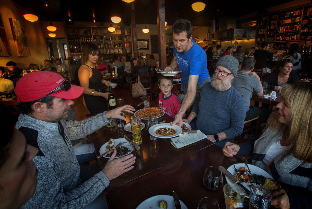 Jerry Corso, owner of Bar del Corso on Beacon Hill, serves guests at his popular restaurant. (Ellen M. Banner / The Seattle Times)