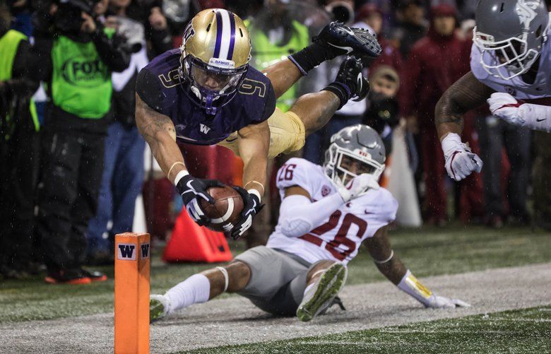 Myles Gaskin sails into the end zone scoring on a 26-yard touchdown in the 3rd quarter.  The Washington State Cougars played the Washington Huskies in the 2017 Apple Cup game at Husky Stadium Saturday, November 25, 2017. 204346