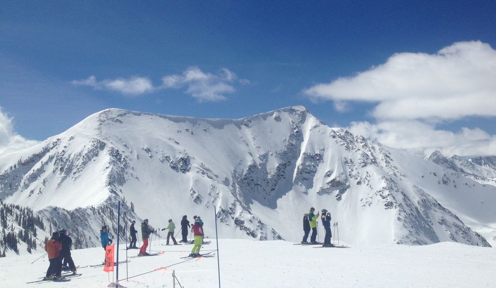 Taking a break from sunny spring laps at Snowbird ski resort, Utah, to admire the view of the American Fork Twin Peaks. (Conor Risch / Special to The Seattle Times)