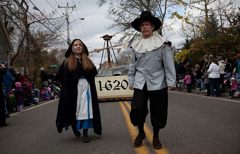 Participants dressed in traditional Pilgrim dress lead the Mayflower float during the Thanksgiving Parade in Plymouth, Mass., Nov. 17, 2012. Blame textbooks, childrenÕs stories or animated specials, but the Thanksgiving story is more complex than most Americans are taught. (Charlie Mahoney/The New York Times)