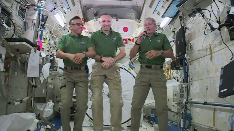 In this undated image provided by NASA,  NASA astronauts Joe Acaba, left, Randy Bresnik, center, and Mark Vande Hei give interviews on the International Space Station. The trio along with their international crewmates plan to feast on pouches of Thanksgiving turkey and single-serving bags of sides on Thursday, Nov. 23, 2017. (NASA via AP)
