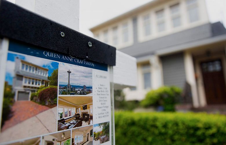 A “For Sale” sign stands in front of a house in Seattle, Washington, U.S., on Sunday, July 20, 2014. Sales of previously owned U.S. homes climbed in June to an eight-month high as more listings helped prices cool, luring buyers into the market. Photographer: Mike Kane/Bloomberg
