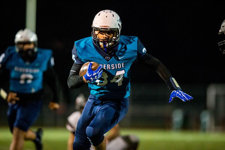 Sam Braboy (34) of Auburn Riverside runs with the ball during the first half against Camas . (Courtney Pedroza/The Seattle Times)