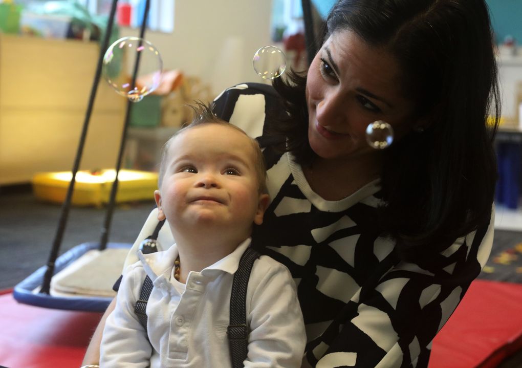 Elsa Calvo tracks bubbles with her 21-month-old son, Franco, who has Down syndrome. He goes to a weekly program at Kindering to work on developmental and sensory exercises. “Kindering not only helps Franco move along in his development, it helps all of us to understand we are not alone,” his mom said. (Ken Lambert/The Seattle Times)