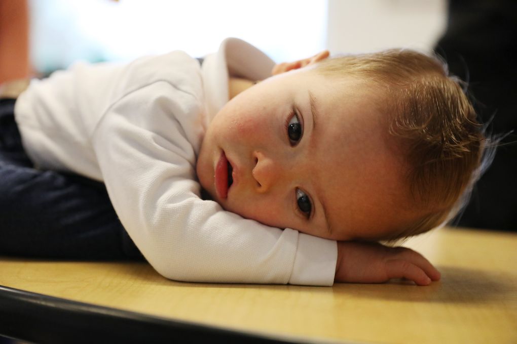 A tired 21-month-old Franco Calvo, of Kirkland, puts his head down after completing his weekly Kindering program. The sessions at Kindering help Franco counteract the developmental delays that come with Down syndrome. (Ken Lambert/The Seattle Times)