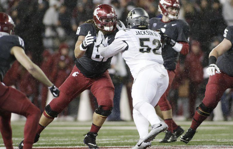 Washington State offensive lineman Cole Madison (61) blocks Colorado defensive end Leo Jackson III (52) during the first half of an NCAA college football game in Pullman, Wash., Saturday, Oct. 21, 2017. (AP Photo/Young Kwak) OTK OTK