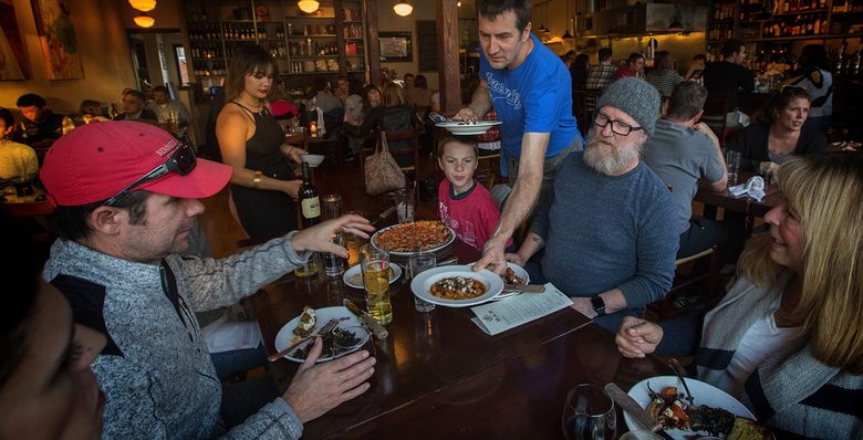Jerry Corso, owner of Bar del Corso on Beacon Hill, serves guests at his popular restaurant. (Ellen M. Banner/The Seattle Times)