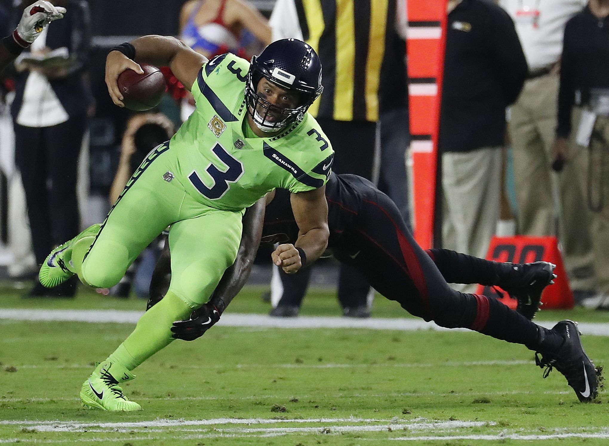 NFC quarterback Russell Wilson of the Seattle Seahawks (3) eyes a receiver  versus the AFC durin …