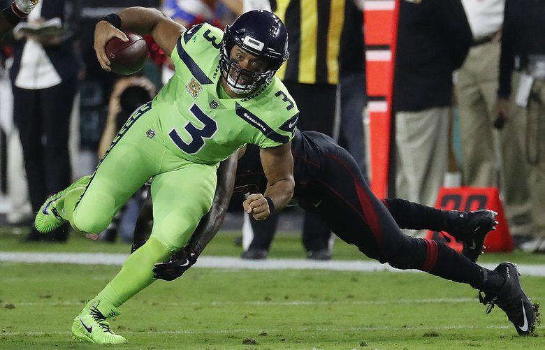 Michael Bennett, all Seahawks, stand for the national anthem on Salute to  Service night vs. Atlanta