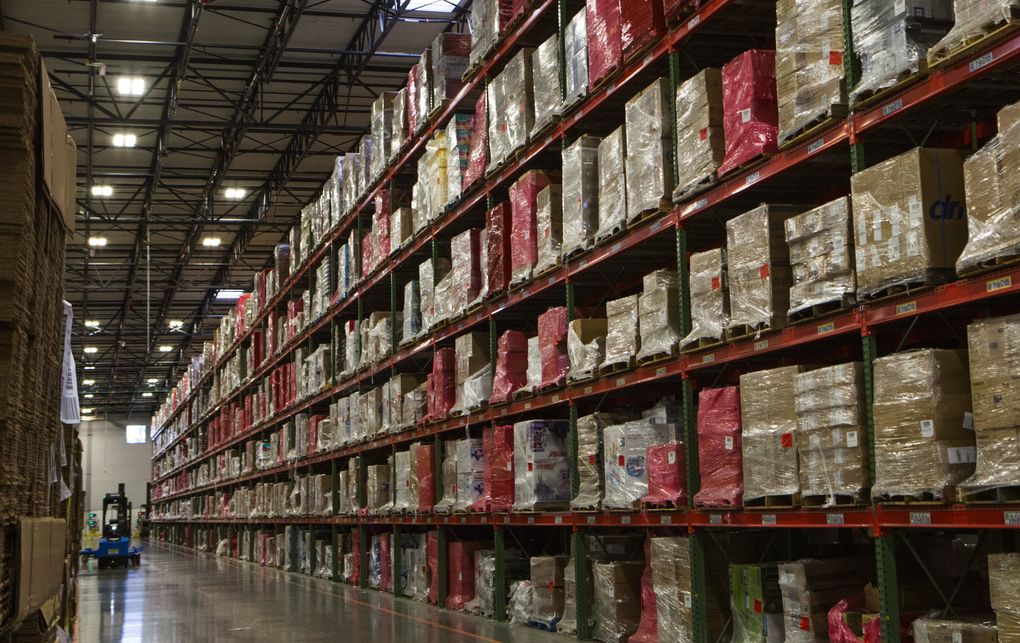 Stacks of merchandise are packed high on shelves ready for distribution in the Amazon Fulfillment Center in DuPont, Pierce County. Amazon offers to calculate and collect sales taxes on behalf of independent merchants, but it’s a service that’s not required. (Ellen M. Banner / The Seattle Times)