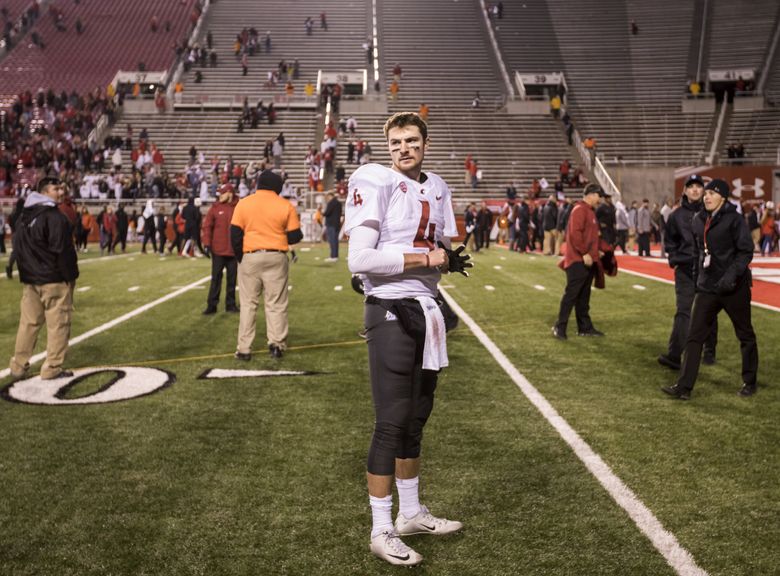 Quarterback Luke Falk stands on the field after helping Washington State defeat Utah last week. It was a sweet victory for Falk, who grew up in Logan, home to Utah State, and was the team Falk grew up rooting for. (Bettina Hansen/The Seattle Times)