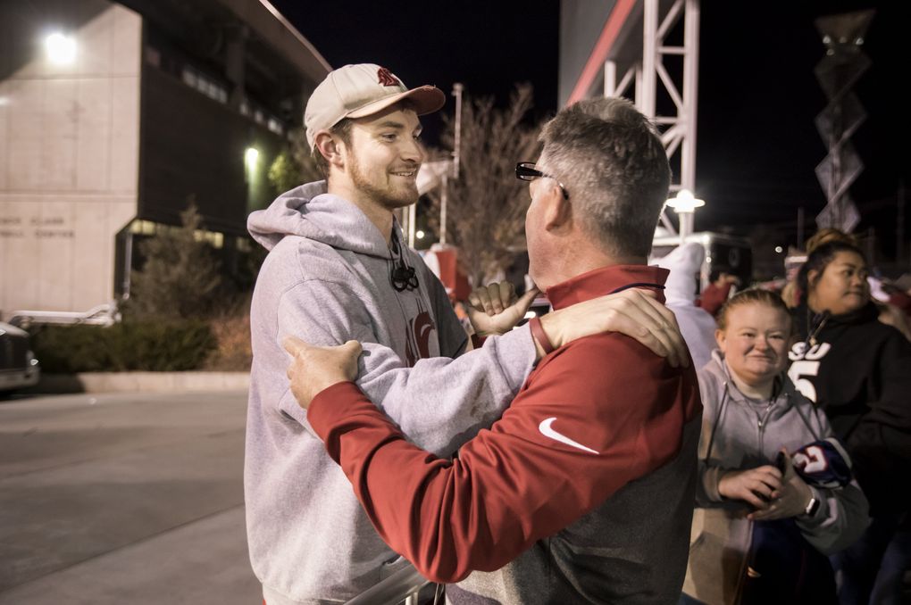 Luke Falk greets his Logan High School football coach, Mike Favero, after Washington State beat Utah. “It was very emotional for me to be able to see him play on that big stage,” Favero said. (Bettina Hansen/The Seattle Times)