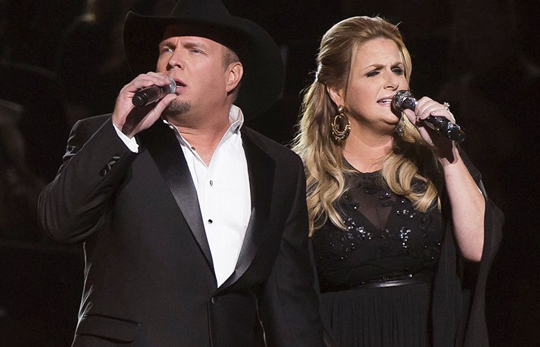 Garth Brooks, left, and Trisha Yearwood perform at the 50th annual CMA Awards at the Bridgestone Arena on Wednesday, Nov. 2, 2016, in Nashville, Tenn. (Photo by Charles Sykes/Invision/AP)