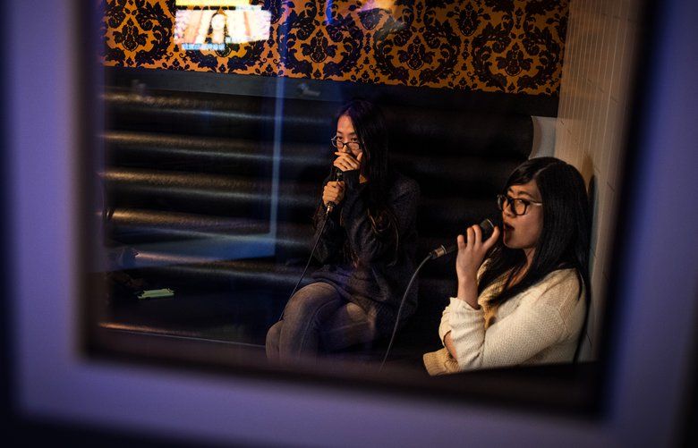 Friends Sylvia, left, and Sherry sing at Party World KTV, a branch of the Asian karaoke chain, in Richmond, British Columbia, Dec. 16, 2017. With thousands of songs in Mandarin and Cantonese, the Richmond satellite of Party World, long a karaoke staple across China, is a microcosm of Canada’s shifting urban cultural landscape. (Aaron Vincent Elkaim/The New York Times) XNYT25 XNYT25