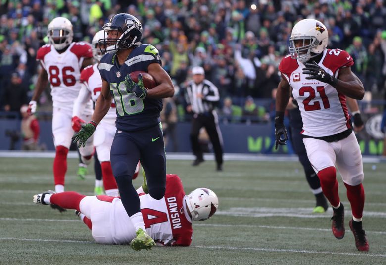 Seattle Seahawks kickoff return team surround Seattle Seahawks wide  receiver Tyler Lockett (16) after he returned a 99-yard kickoff or a  touchdown against the Arizona Cardinals during the first quarter at  CenturyLink