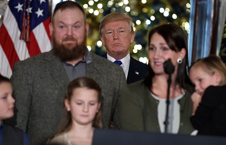 President Donald Trump listens people speak in support of Republican tax policy reform, during an event in the Grand Foyer of the White House, Wednesday, Dec. 13, 2017, in Washington. (AP Photo/Evan Vucci) DCEV109 DCEV109