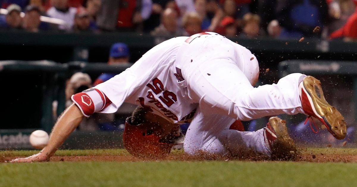 Ball sticks in chest protector of St. Louis Cardinals catcher