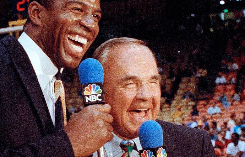 FILE – In this Feb. 2, 1992, file photo, Earvin “Magic” Johnson, left, and veteran sportscaster Dick Enberg laugh during commentary before the Los Angeles Lakers-Chicago Bulls NBA basketball game in Inglewood, Calif. This was Johnson’s debut as a sports commentator. Enberg, the sportscaster who got his big break with UCLA basketball and went on to call Super Bowls, Olympics, Final Fours and Angels and Padres baseball games, died Thursday, Dec. 21, 2017. He was 82. Engberg’s daughter, Nicole, confirmed the death to The Associated Press. She said the family became concerned when he didn’t arrive on his flight to Boston on Thursday, and that he was found dead at his home in La Jolla, a San Diego neighborhood. (AP Photo/Doug Pizac, File)
