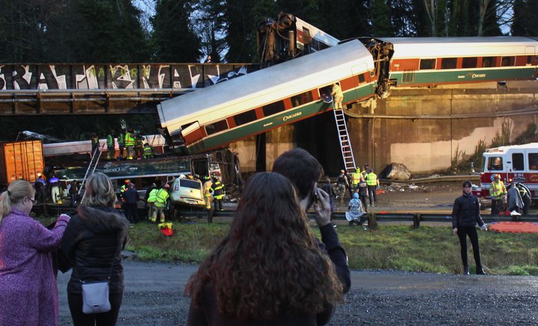 Emergency crews work at the scene of the Amtrak 501 train derailment near DuPont on Monday.  (Daniella Fenelon/The Associated Press)