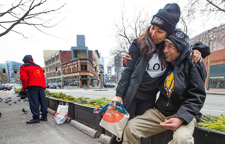 Amy Han gives Santokh Singh, a hug after after supplying him with a sandwich and a water. Han and co-workers at Swedish Hospital make sandwiches and pass them out to homeless people on the street. The group made the sandwiches at Han’s house then passed them out on Second Avenue Ext. South in Pioneer Square later in the morning.
