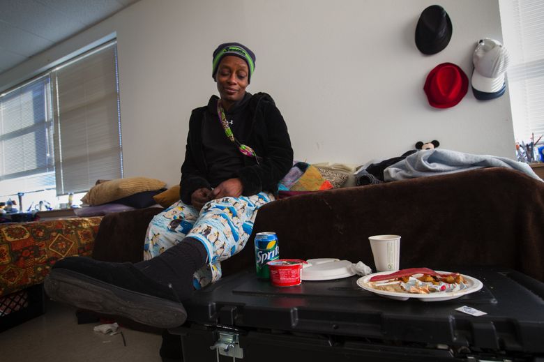 Jacqueline Martin sits on her bed and talks about life at the Navigation Center in Seattle, where she has been living since July. She plans to go to law school and to become a lawyer. (Ellen M. Banner/The Seattle Times)