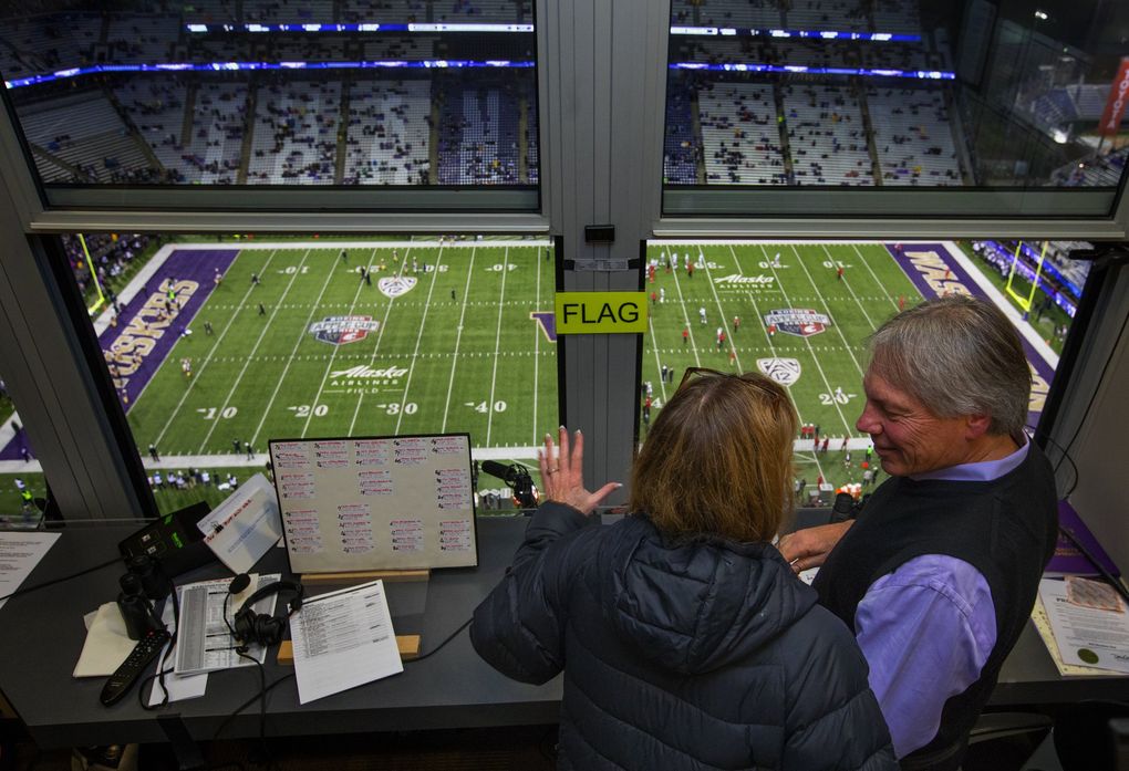 Bob Rondeau and his wife Molly chat in his radio booth before he announces his last game at Husky Stadium — the Apple Cup — Saturday, November 25, 2017. (Ellen M. Banner / The Seattle Times)
