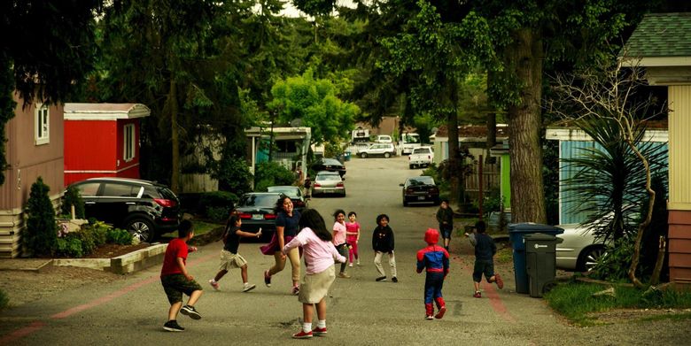 Children play at the Firs Mobile Home Park in SeaTac. Fifty-two families currently live in the community, including around 90 children. (Erika Schultz / The Seattle Times)