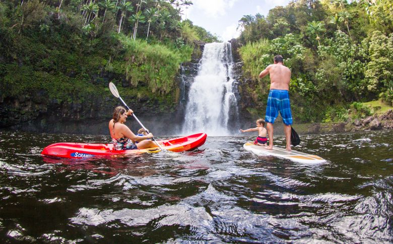 On a Hawaii Forest & Trail tour, visitors may try kayaking or stand-up paddleboarding amid spray at the base of Kulaniapia Falls, near Hilo, Hawaii. (Jason Cohn photo)
