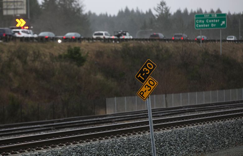 A sign along the tracks near the Center Drive exit in Dupont shot  Monday, December 18, 2017.  Southbound lanes of I-5 can be seen at top of frame.