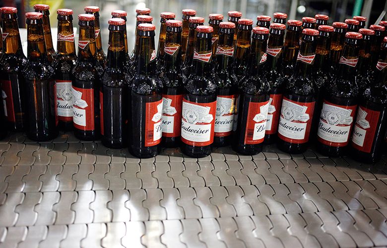 Bottles of beer move along a conveyor belt at the Anheuser-Busch InBev NV Budweiser bottling facility in St. Louis, Missouri, U.S., on Tuesday, Oct. 24, 2017. Anheuser-Busch InBev is scheduled to release earnings figures October 26. Photographer: Luke Sharrett/Bloomberg