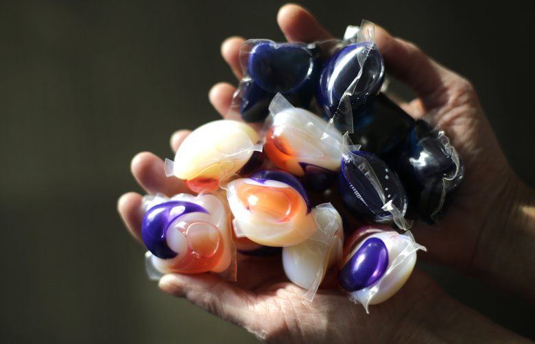 In this photo taken Friday, Nov. 7, 2014, laundry detergent packets are held for a photo, in Chicago. Accidental poisonings from squishy laundry detergent packets sometimes mistaken for toys or candy landed more than 700 U.S. children in the hospital in just two years, researchers report. Coma and seizures were among the most serious complications. (AP Photo/Charles Rex Arbogast) ILCA202