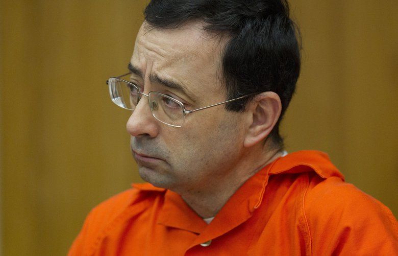 Larry Nassar appears for his sentencing at Eaton County Circuit Court in Charlotte, Mich., on Wednesday, Jan. 31, 2018. The former Michigan State University sports-medicine and USA Gymnastics doctor is being sentenced for three first degree criminal sexual abuse charges related to assaults that occurred at Twistars, a gymnastics facility in Dimondale. Nassar has also been sentenced to 60 years in prison for three child pornography charges in federal court and between 40 to 175 years in Ingham County for seven counts of criminal sexual conduct. (Cory Morse /The Grand Rapids Press via AP) MIGRA104 MIGRA104