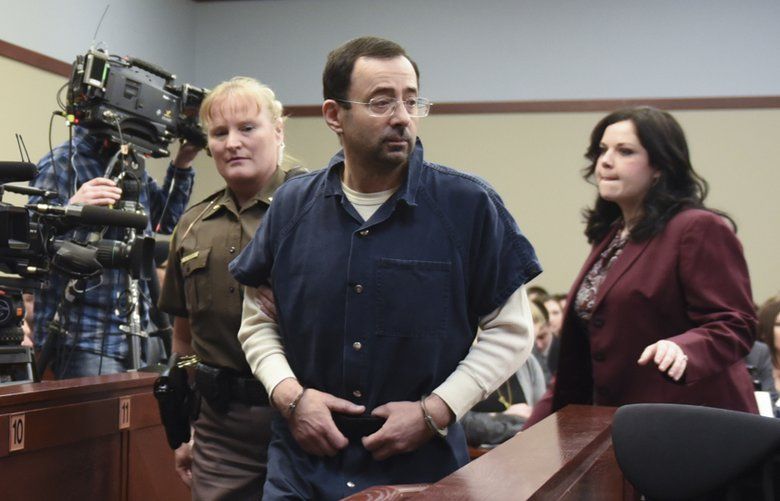 Larry Nassar enters circuit court Thursday, Jan. 18, 2018, during the third day of victim impact statements in Lansing, Mich. Nassar, 54, faces a minimum sentence of 25 to 40 years in prison for molesting girls at Michigan State University and his home. He also was a team doctor at USA Gymnastics, based in Indianapolis, which trains Olympians. He’s already been sentenced to 60 years in federal prison for child pornography crimes.   (Matthew Dae Smith/Lansing State Journal via AP) MILAN101 MILAN101