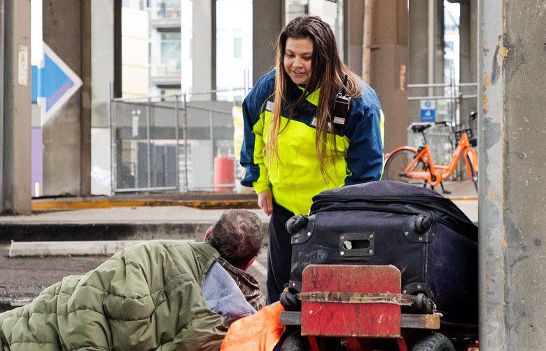 Fawn Batten is a downtown Seattle safety ambassador who wakes up homeless people every morning and checks on them.  Batten checks on a man sleeping under the Alaskan Way Viaduct on January 25, 2018. 205001