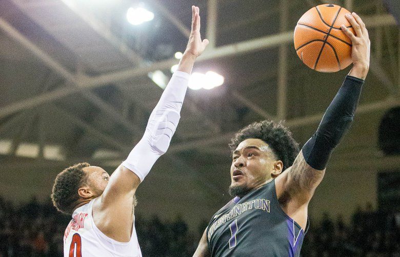 Washington Huskies guard David Crisp (1) goes up to the hoop against Arizona Wildcats guard Parker Jackson-Cartwright (0) during the first half at Alaska Airlines Arena in Seattle on Saturday Feb. 3, 2018.  (Courtney Pedroza / The Seattle Times)