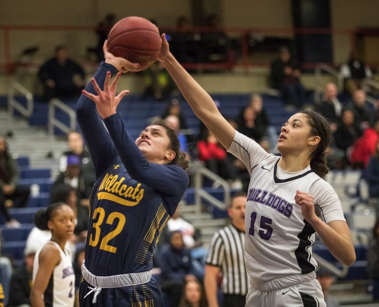 Garfield’s Dalayah Daniels (15) gets the block on the shot from behind of West Seattle’s Meghan Fiso in the 1st half. (Dean Rutz / The Seattle Times)