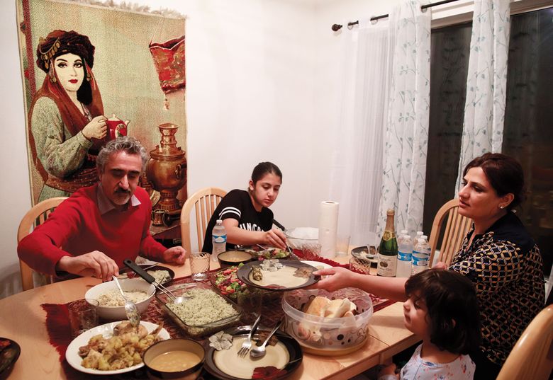 Clockwise, from left: Aso Shwany, 41; his daughter Yasna, 12; wife Avan, 38; and daughter Kobani, 3, eat dinner in their home in Maple Valley. (Erika Schultz/The Seattle Times)