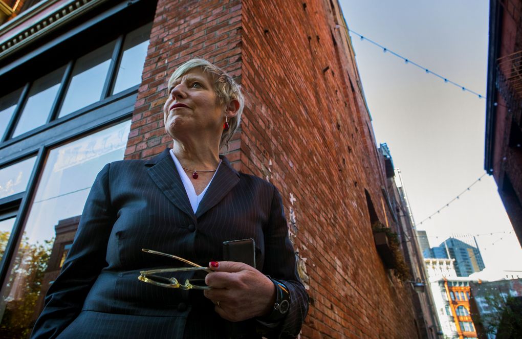 Lianne Dalziel, the mayor of Christchurch, New Zealand, stops during a walking tour of Pioneer Square, where the many old brick buildings remind her of those destroyed in her city by a 2011 earthquake. (Ellen M. Banner/The Seattle Times)