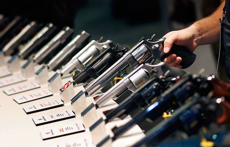 FILE – In this Jan. 19, 2016 file photo, handguns are displayed at a trade show in Las Vegas. With protesters outside the courthouse calling for action, a Nevada judge is due to hear arguments about a voter-approved gun background-check law that has not been enforced since voters passed it in November 2016. The Friday, Feb. 23, 2018, hearing stems from a lawsuit filed in October, just days after a gunman shot into an open-air concert crowd on the Las Vegas Strip, killing 58 people and injuring hundreds. (AP Photo/John Locher, File)