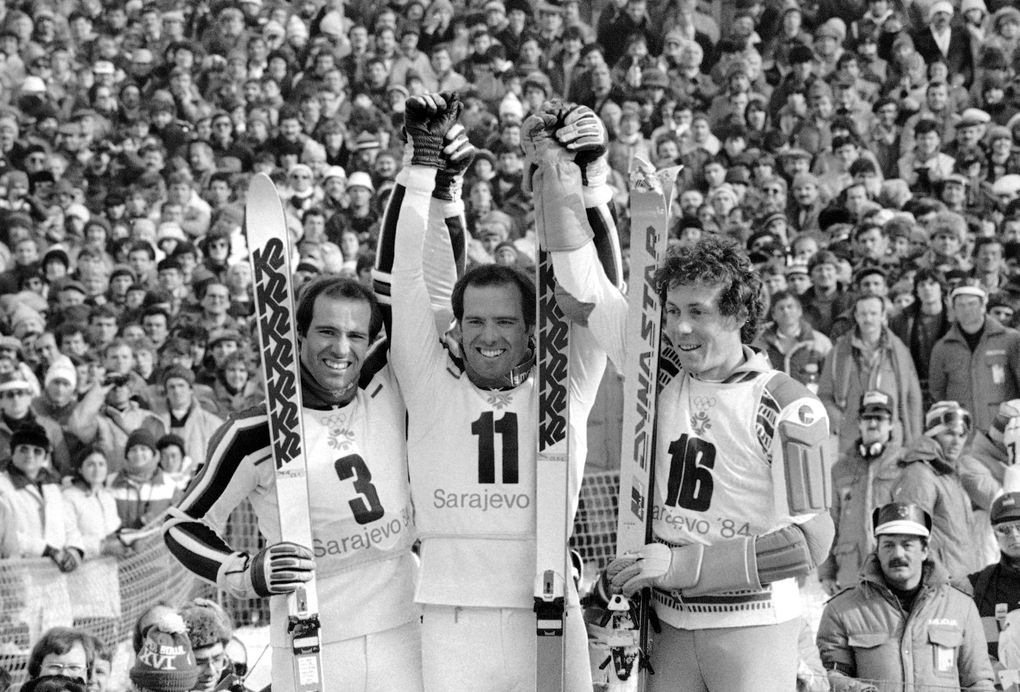 Phil Mahre is flanked by his twin brother Steve, left, and French skier Didier Bouvet in the podium on Mt. Bjelasnica, on Sunday, Feb. 19, 1984 in Sarajevo after the men’s special slalom event, the last alpine competition on the last day of the XIV Winter Olympic Games. Phil won the gold medal, Steve placed second winning silver and Bouvet claimed bronze. (AP Photo/KS) (KS/AP)
