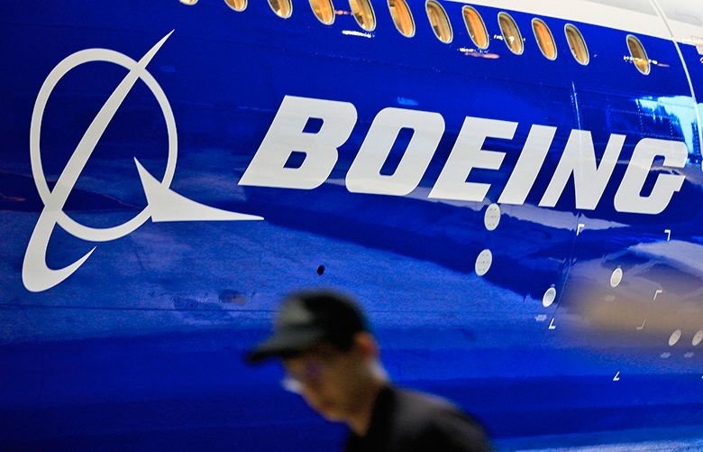 epa05749559 (FILE) – A file photo dated 14 June 2016 showing a man walking past a logo of US aircraft manufacturing company Boeing at Taoyuan airport, in Taoyuan, Taiwan. Boeing on 25 January 2017 reported a full-year 2016 revenue of 94.6 billion USD, and a full year net earnings of 4,89 billion USD.  EPA/RITCHIE B. TONGO