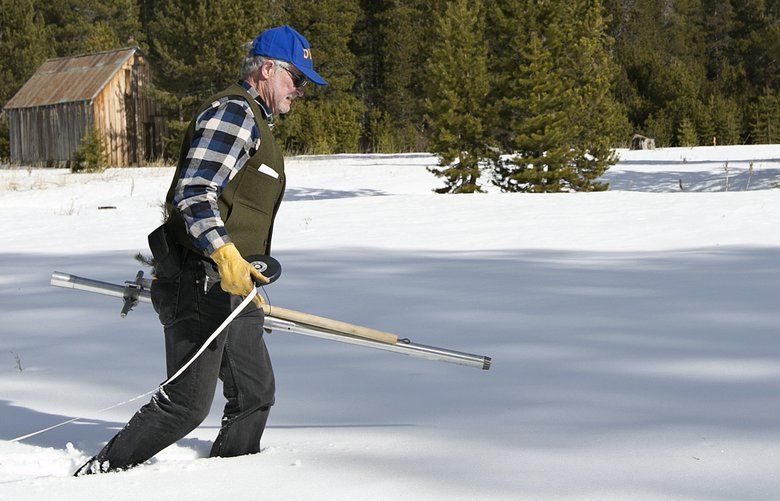FILE – In this Feb. 1, 2018 file photo Frank Gehrke, chief of the California Cooperative Snow Surveys Program for the Department of Water Resources, crosses a snow covered meadow as he conducts the second snow survey of the season near Echo Summit, Calif. A new study led by scientists at Oregon State University has found that snowpack has declined dramatically across the American West over the past century. (AP Photo/Rich Pedroncelli,File) LA503 LA503