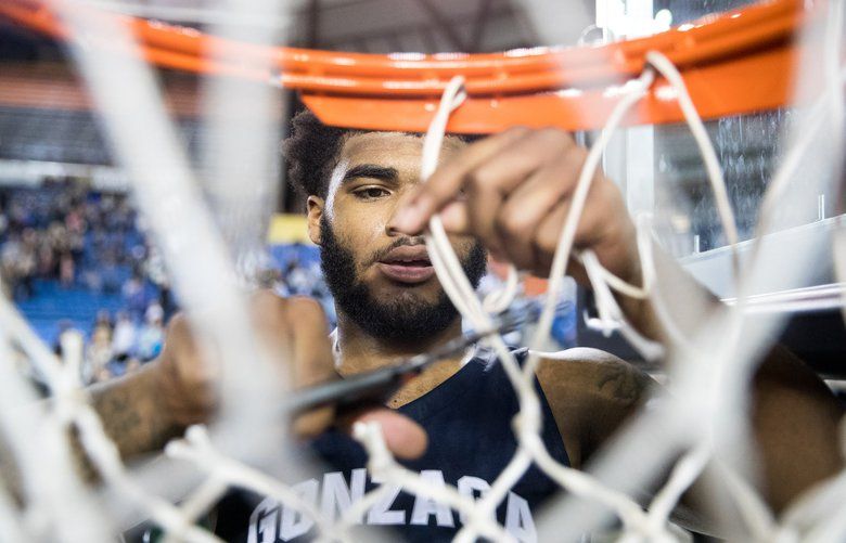 Devin Culp (20) of Gonzaga Prep cuts the net off of the rim after beating Federal Way after the Hardwood Classic 4A championship game at the Tacoma Dome, on Saturday, March 3, 2018, in Tacoma.
 205390