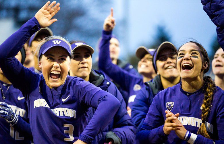 Washington infielders Taryn Atlee (7) and Taylor Van Zee (3) celebrate with their team after beating Arizona 2-1 in an extra inning at Husky Softball Stadium in Seattle on Friday, March 23, 2018.  205743