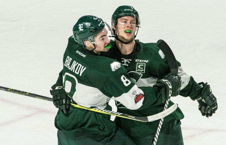 Matt Fonteyne, right, scores the empty-net goal giving Everett a 3-1 lead over the Thunderbirds with just over 30 seconds to play in the game Tuesday.  The Everett Silvertips played the Seattle Thunderbirds in the 3rd game of their best of WHL Western Conference playoff series Tuesday, March 27, 2018 at ShoWare Center in Kent. 205759