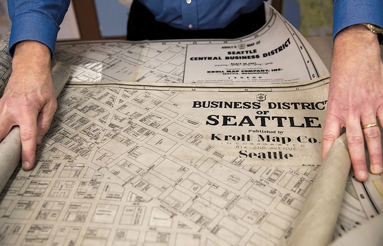 John Loacker spreads out two hand-drawn Kroll maps of Seattle’s central business district, the top on imperial tracing cloths, used from the 1930s to the 1960s, and the second on mylar, used from approximately the 1960s to the 1980s. Before computers, the master versions of the undated maps were just touched up and revised as construction and businesses changed the city.


Photographed Thursday January 4, 2018.