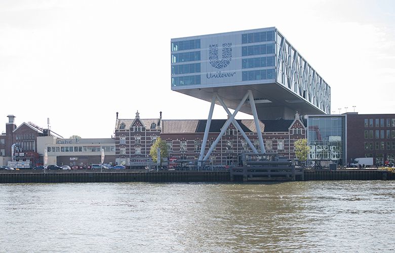 The Unilever logo sits on the Unilever NV headquarter offices as it stands beside the River Maas in Rotterdam, Netherlands, on Thursday, May 11, 2017. Unilever Plc’s announcement that it’s looking at ending its dual nationality and basing itself in London or Rotterdam means Theresa May finds her Brexit strategy facing either a big endorsement or an early blow. Photographer: Jasper Juinen/Bloomberg